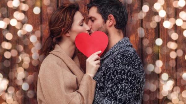 couple kissing behind a heart - signs you're in love